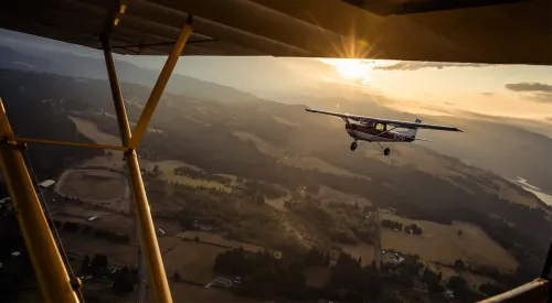 Airplane flying in sunset